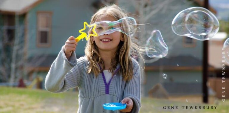Candid photo of child with bubbles